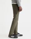 Side view of model wearing Army Green Comfort Knit Chinos, Slim Fit.