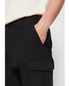 View of model wearing Beautiful Black Cargo Pants, Slim Tapered Fit.
