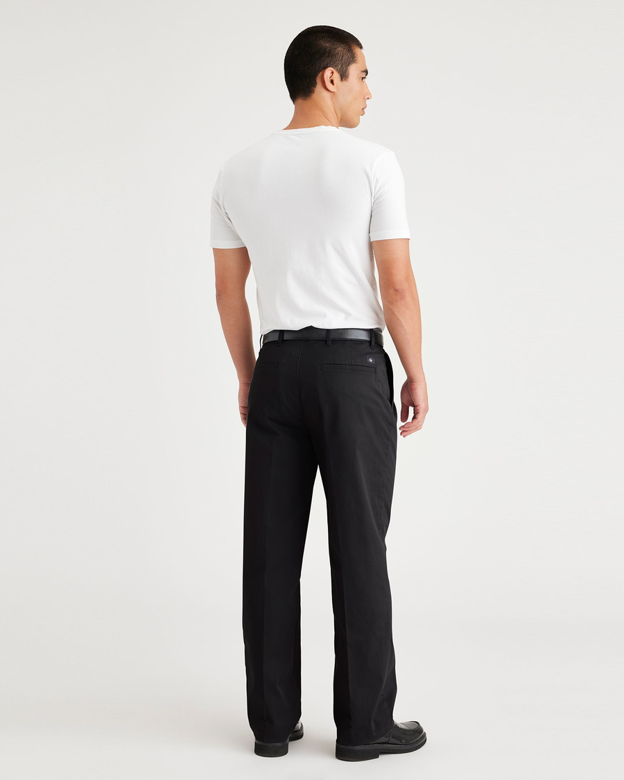 Back view of model wearing Beautiful Black Essential Chinos, Pleated, Classic Fit.