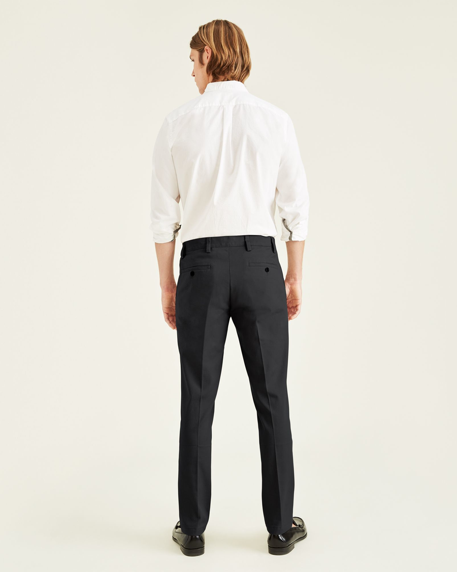Back view of model wearing Black Easy Khakis, Slim Fit.