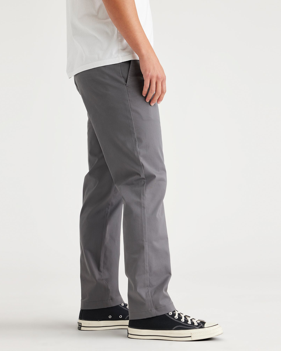 Side view of model wearing Car Park Grey Essential Chinos, Slim Fit.
