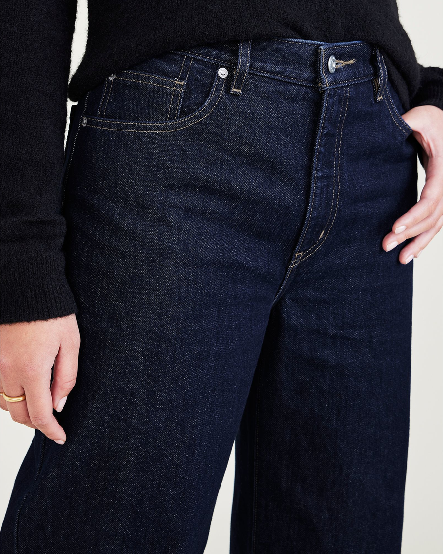 View of model wearing Dark Indigo Stonewash Mid-Rise Jeans, Relaxed Fit.