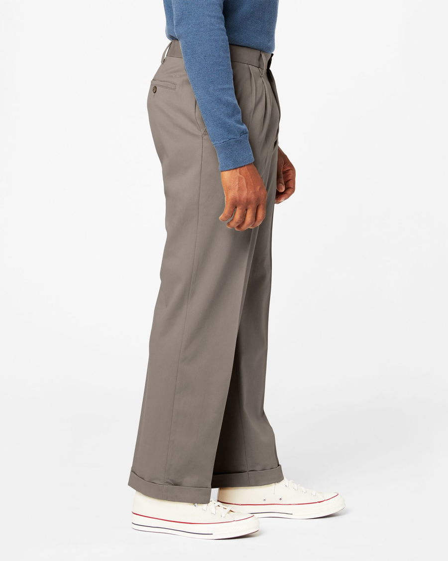 Side view of model wearing Dark Pebble Comfort Khakis, Pleated, Relaxed Fit.