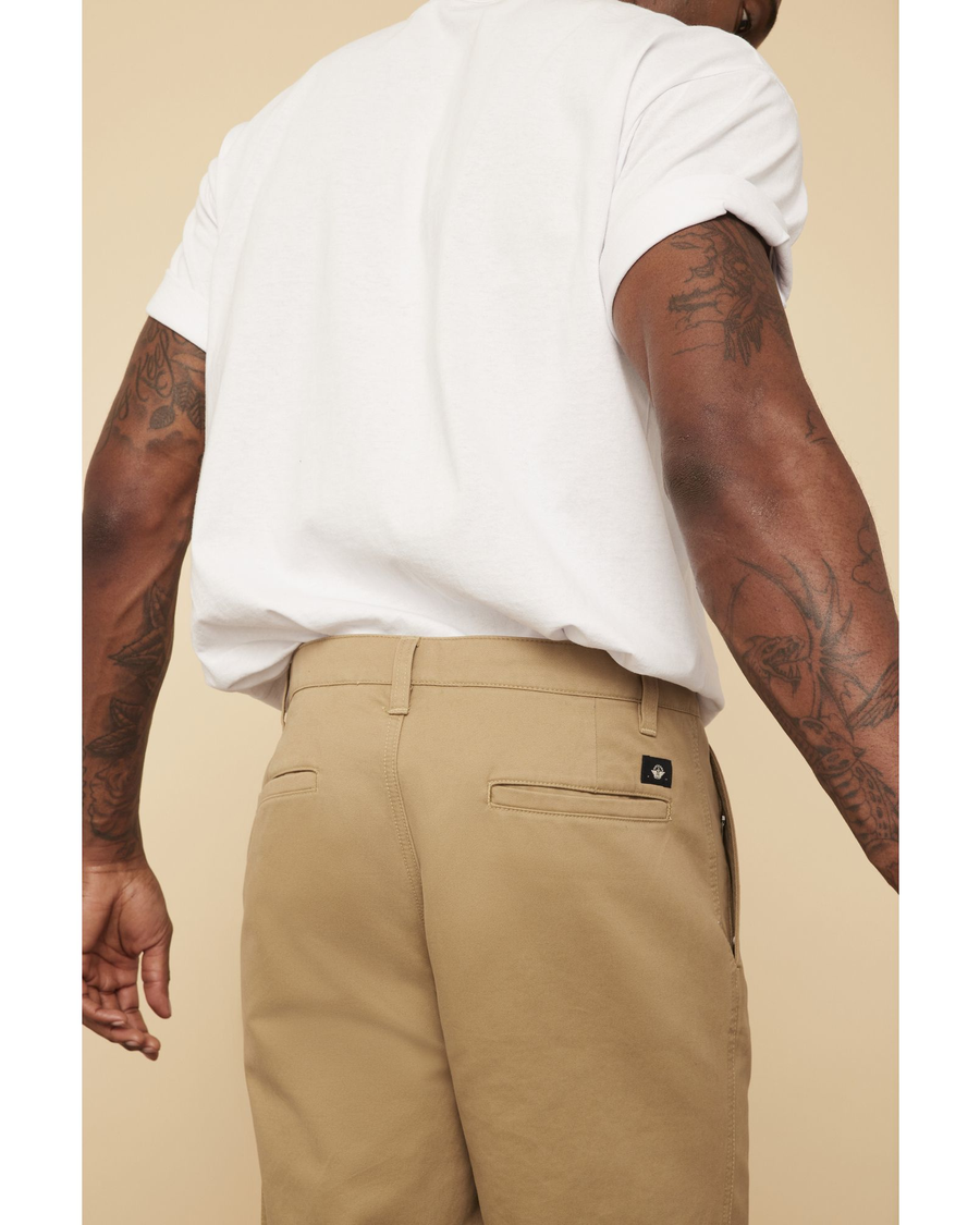 View of model wearing Golden Khaki Dockers® Made in the USA Chinos, Relaxed Tapered Fit.