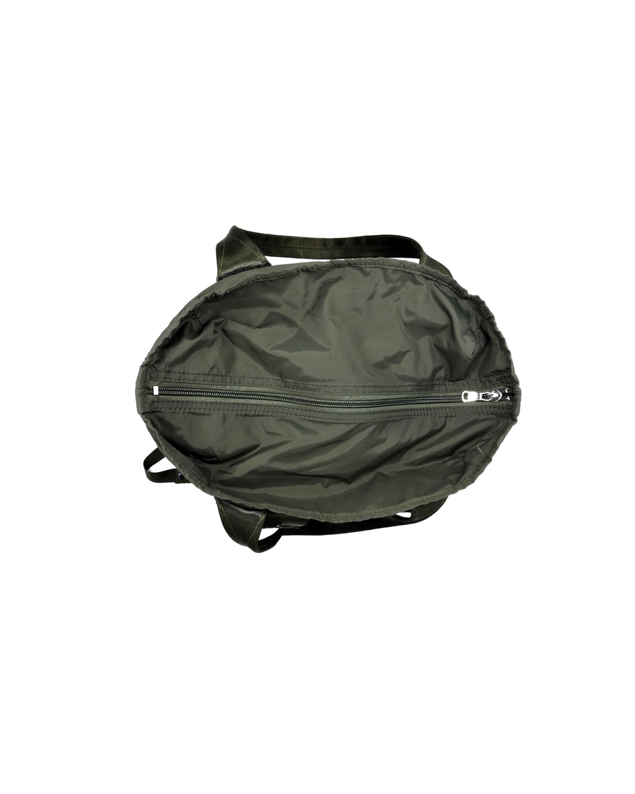 View of model wearing Green Packable Backpack.