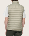 Back view of model wearing Green Packable Puffer Vest.