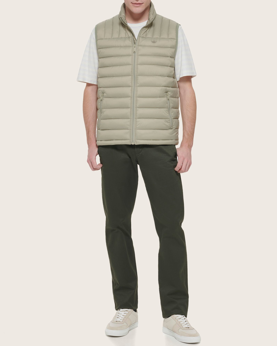Front view of model wearing Green Packable Puffer Vest.
