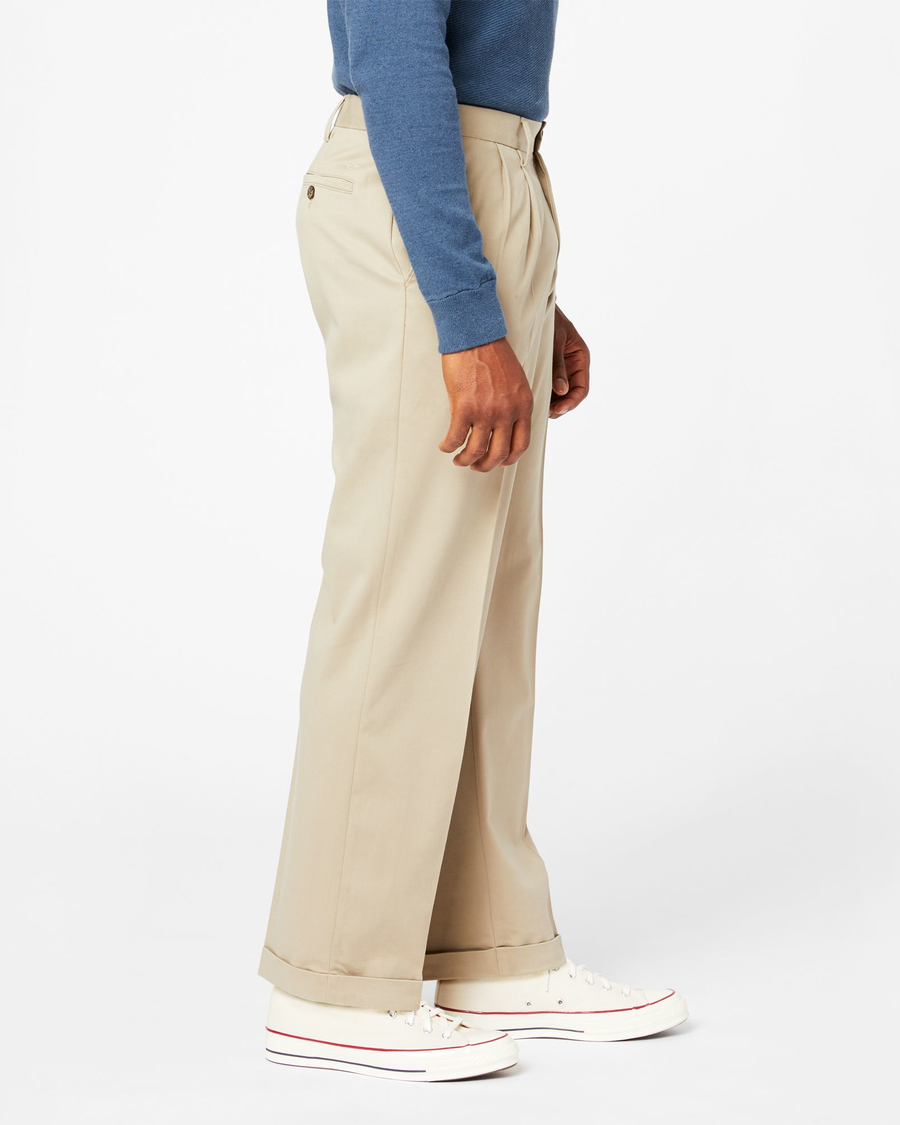 Side view of model wearing Khaki Comfort Khakis, Pleated, Relaxed Fit.