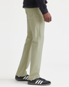 Side view of model wearing Lint Jean Cut Pants, Straight Fit.