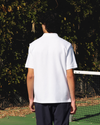View of model wearing Lucent White Racquet Club All Court Polo, Regular Fit.