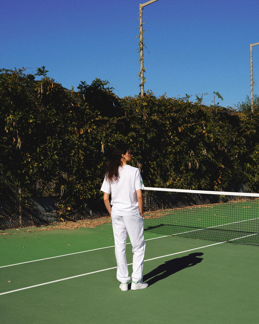 View of model wearing Lucent White Racquet Club Court Pant, Relaxed Tapered Fit.