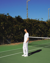 View of model wearing Lucent White Racquet Club Court Pant, Relaxed Tapered Fit.