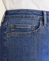 View of model wearing Medium Indigo Stonewash Jean Cut Pants, High Slim Fit.