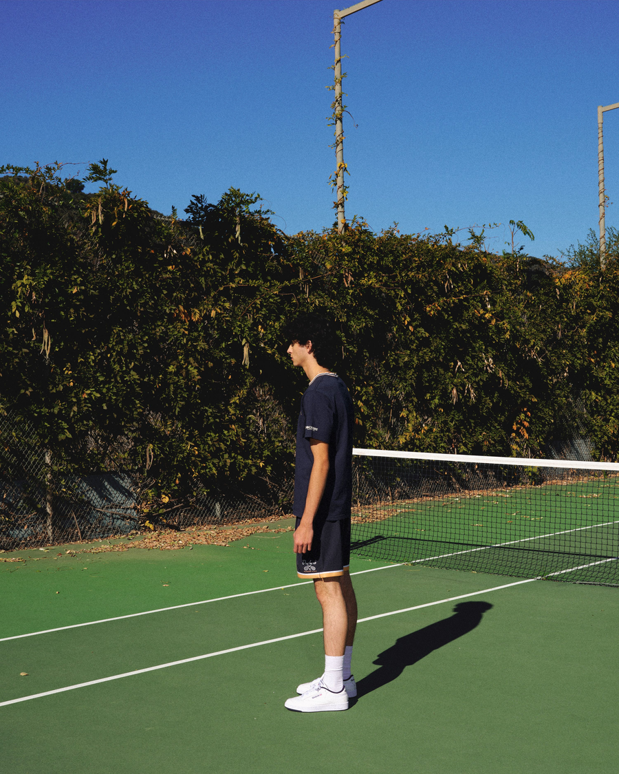 View of model wearing Navy Blazer Racquet Club Retro 5.5" Short, Relaxed Fit.