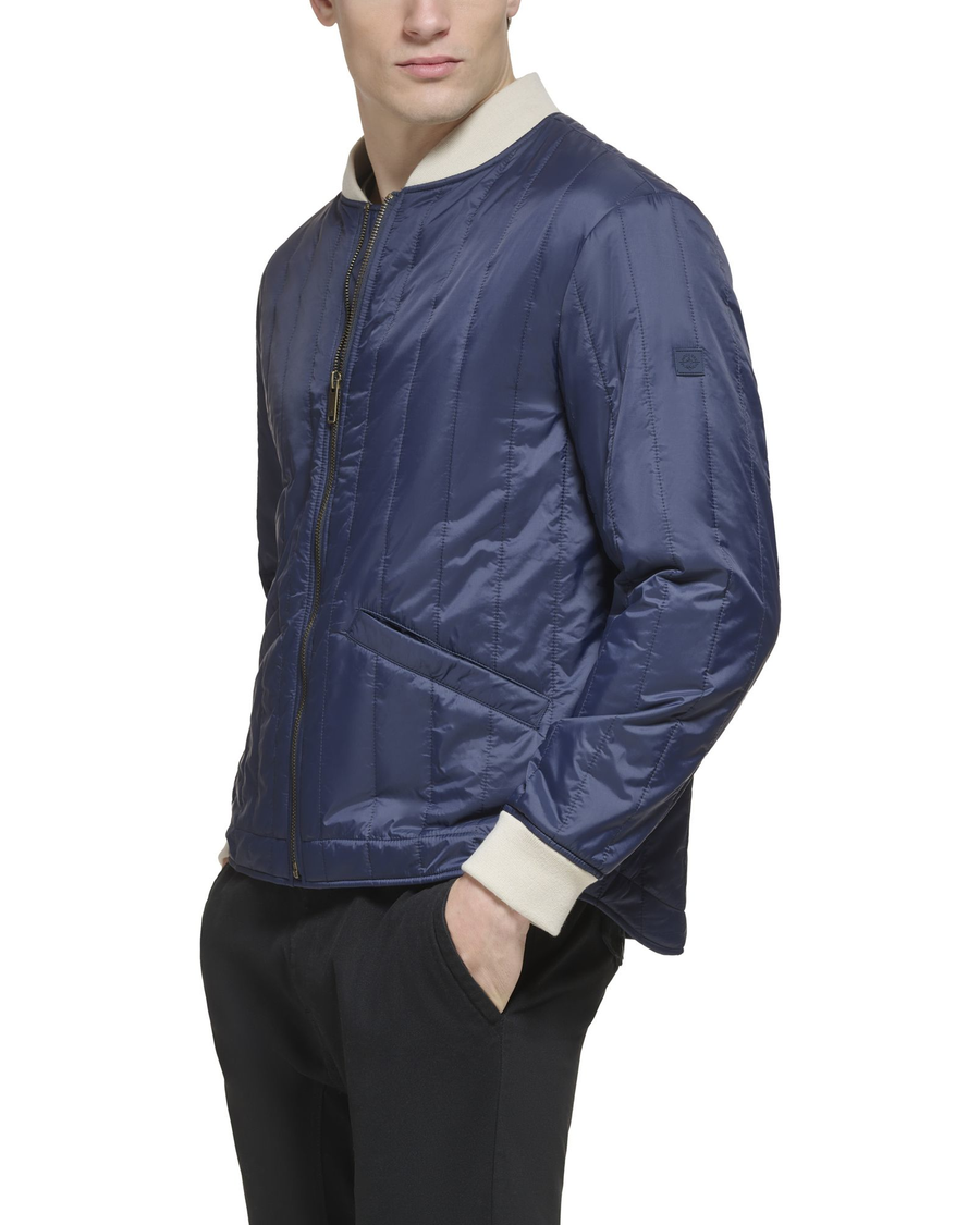 Side view of model wearing Navy Blazer Recycled Nylon Channel Quilted Bomber Jacket.