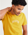 View of model wearing Nugget Gold Varsity Arch Graphic Tee, Slim Fit.