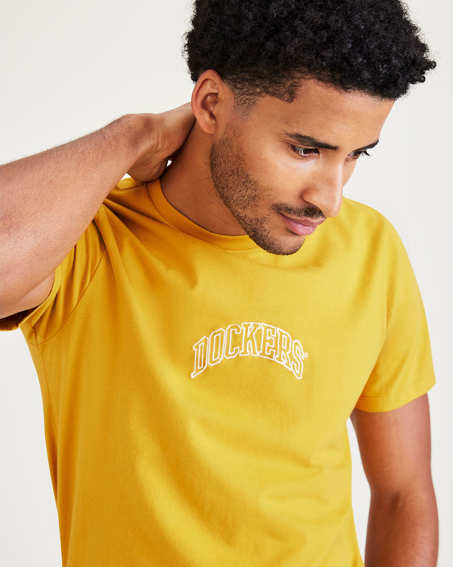 View of model wearing Nugget Gold Varsity Arch Graphic Tee, Slim Fit.