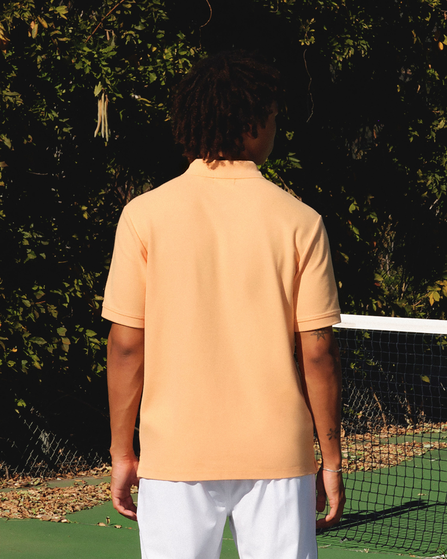View of model wearing Orange Chiffon Racquet Club All Court Polo, Regular Fit.