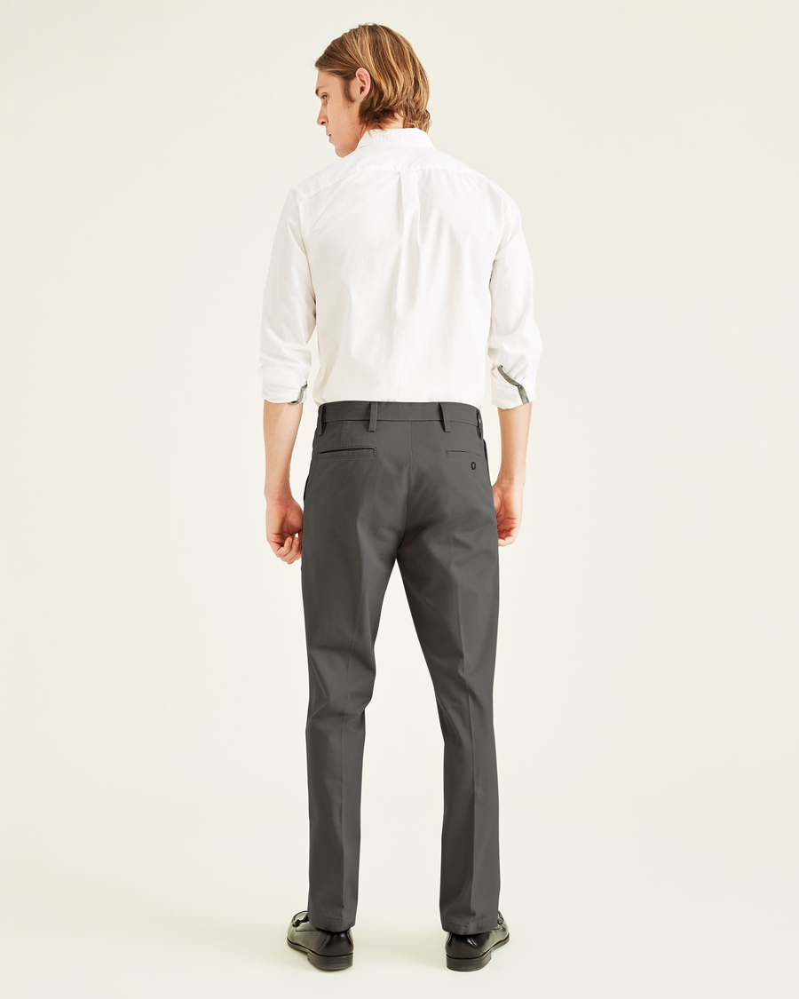 Back view of model wearing Storm Workday Khakis, Slim Fit.