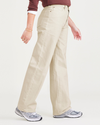 Side view of model wearing Tan Mid-Rise Jeans, Relaxed Fit.