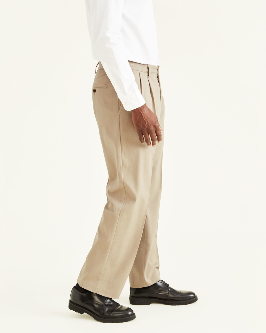 Side view of model wearing Timber Wolf Easy Khakis, Pleated, Classic Fit.