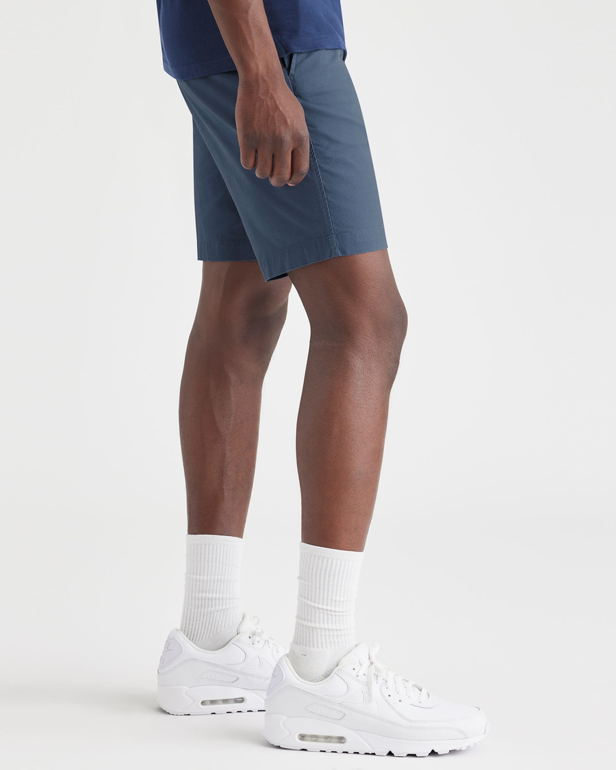 Side view of model wearing Vintage Indigo Ultimate 9.5" Shorts, Straight Fit.