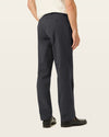 Back view of model wearing Black Workday Khakis, Classic Fit.