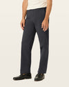 Side view of model wearing Black Workday Khakis, Classic Fit.
