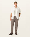 Front view of model wearing Dark Pebble Signature Iron Free Khakis, Straight Fit with Stain Defender®.