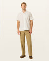 Front view of model wearing New British Khaki Signature Iron Free Khakis, Relaxed Fit with Stain Defender®.