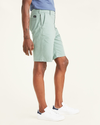 Side view of model wearing Agave Green Ultimate 9.5" Shorts (Big and Tall).