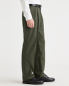 Side view of model wearing Army Green Signature Iron Free Khakis, Pleated, Classic Fit with Stain Defender®.