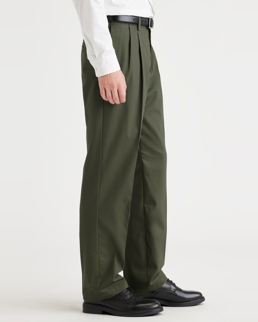 Side view of model wearing Army Green Signature Iron Free Khakis, Pleated, Classic Fit with Stain Defender®.