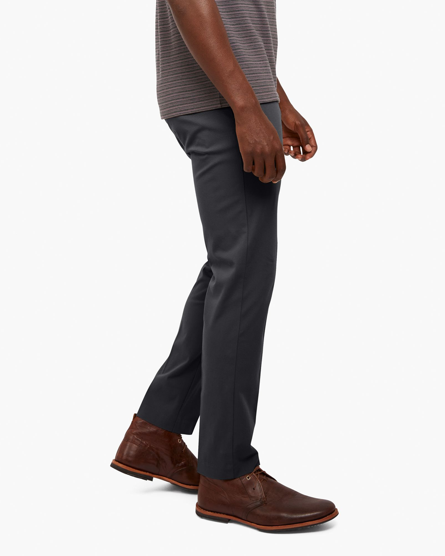 Side view of model wearing Asphalt City Tech Trousers, Slim Fit.
