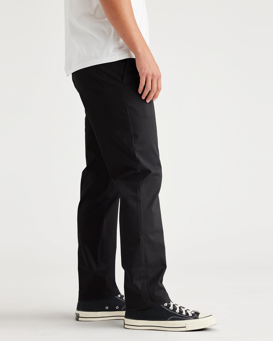 Side view of model wearing Beautiful Black Essential Chinos, Slim Fit.