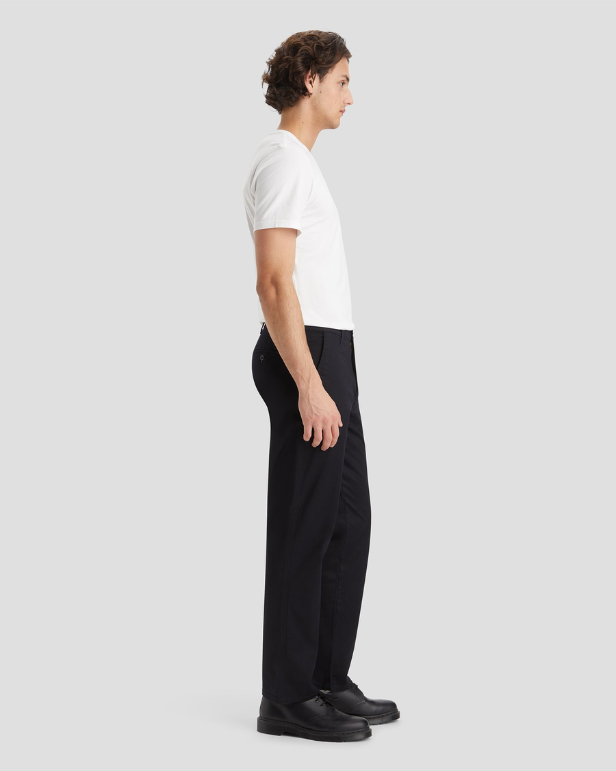 Side view of model wearing Beautiful Black Original Chinos, Straight Fit.