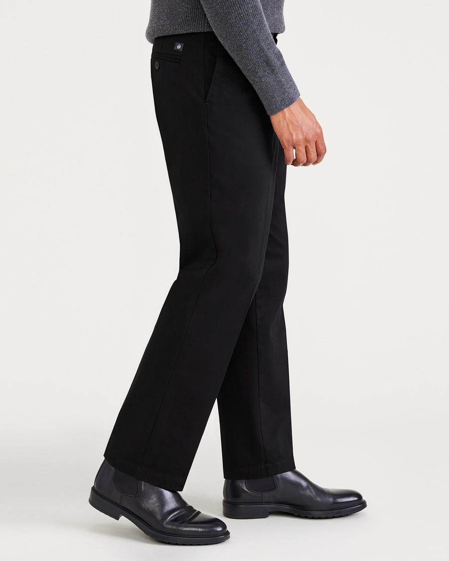 Side view of model wearing Beautiful Black Signature Iron Free Khakis, Pleated, Classic Fit with Stain Defender® (Big and Tall).