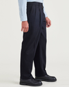 Side view of model wearing Beautiful Black Signature Iron Free Khakis, Pleated, Relaxed Fit with Stain Defender®.