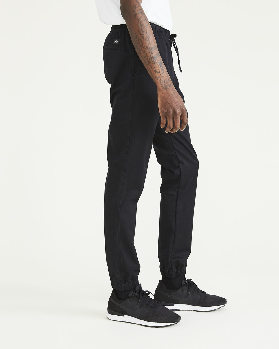 Side view of model wearing Beautiful Black Ultimate Joggers, Slim Fit.