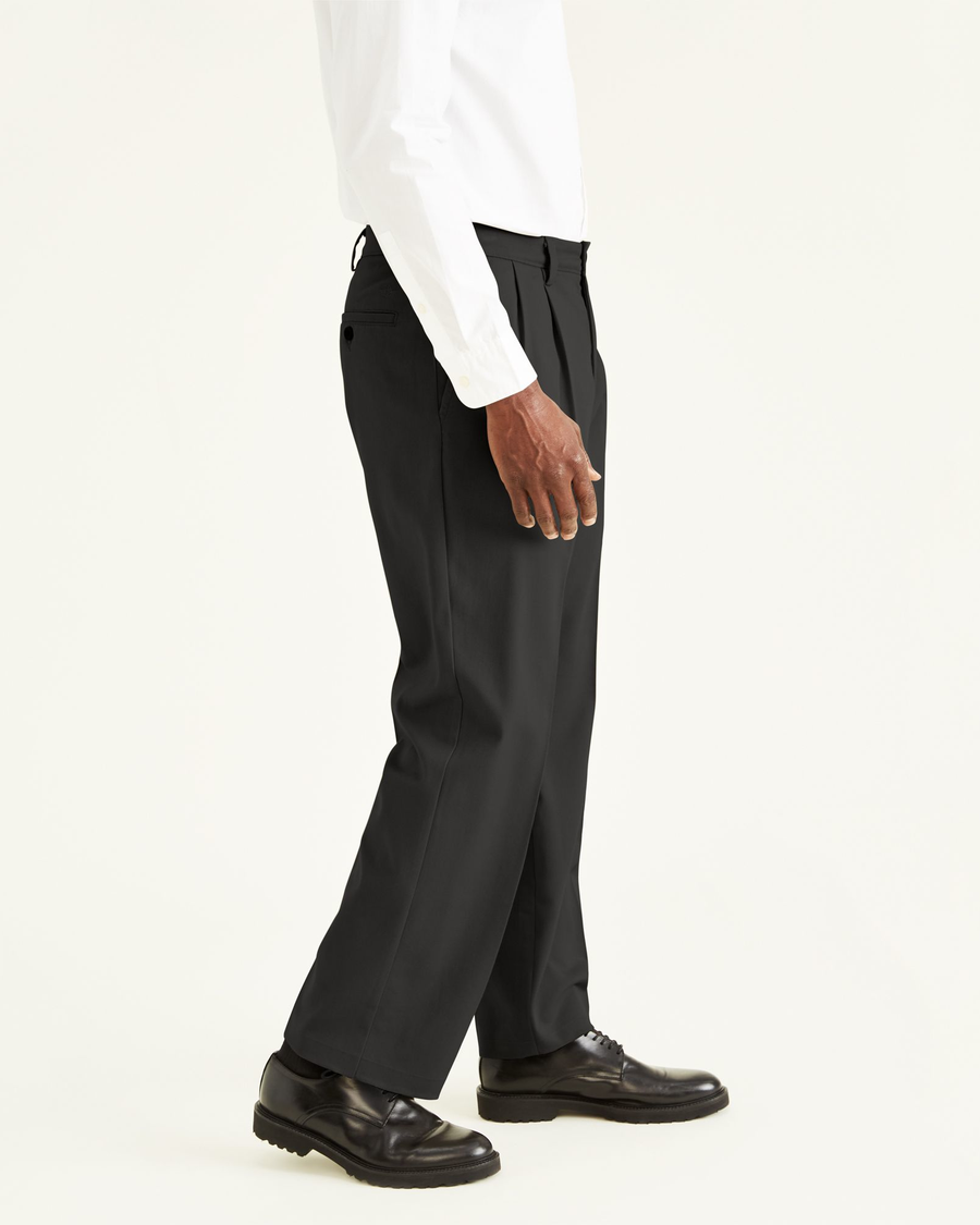 Side view of model wearing Black Easy Khakis, Pleated, Classic Fit.