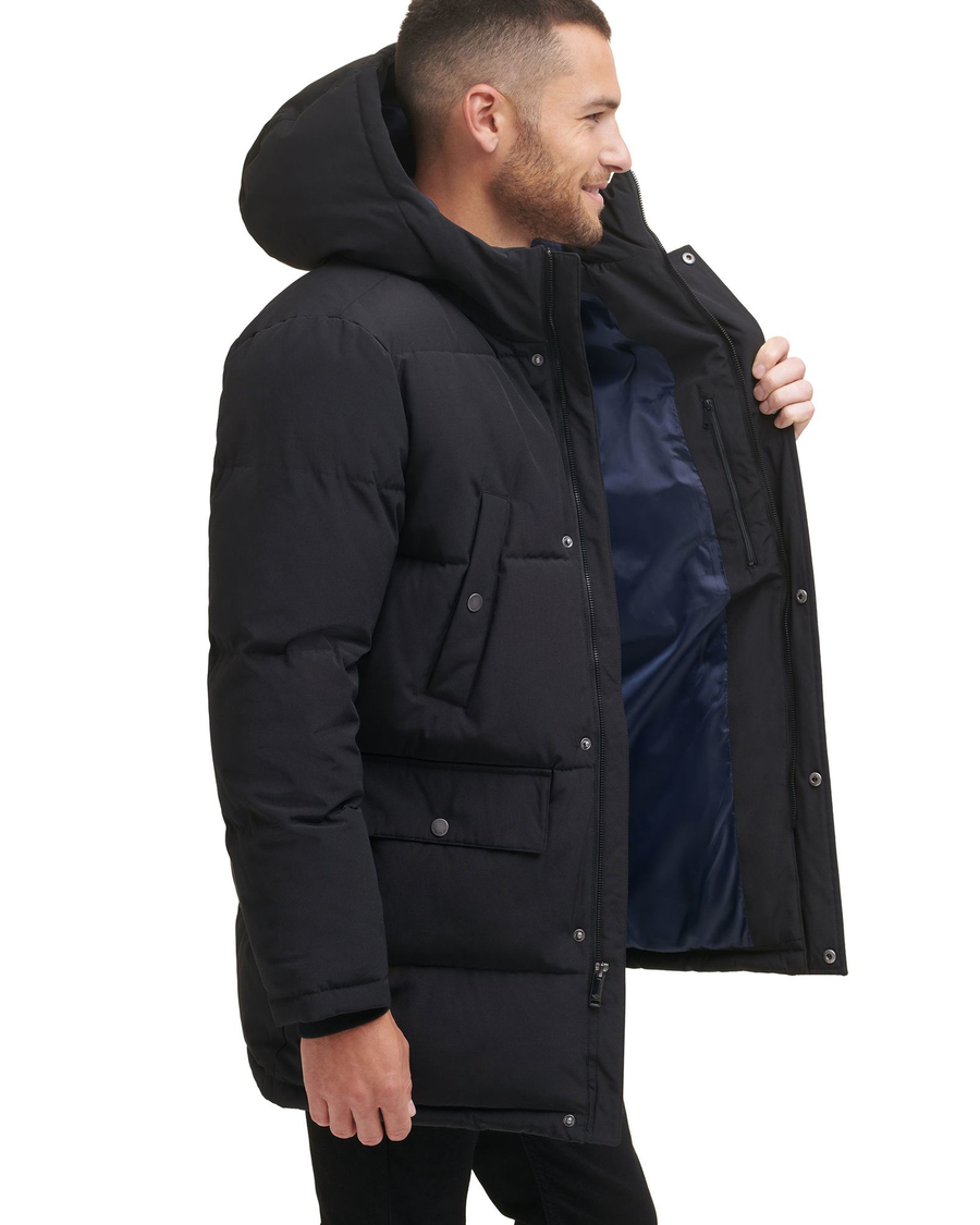 Side view of model wearing Black Quilted Arctic Hooded Parka.
