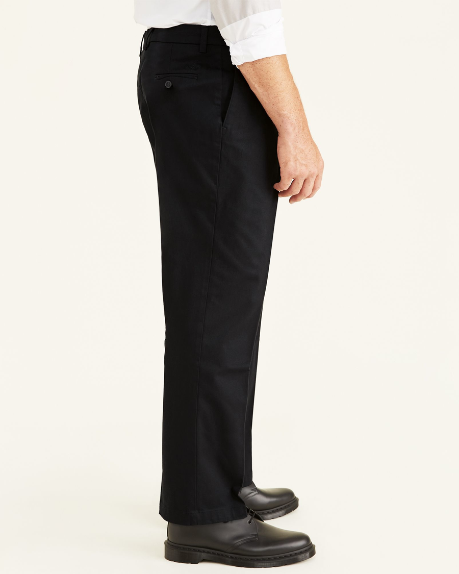 Side view of model wearing Black Signature Khakis, Pleated, Classic Fit (Big and Tall).