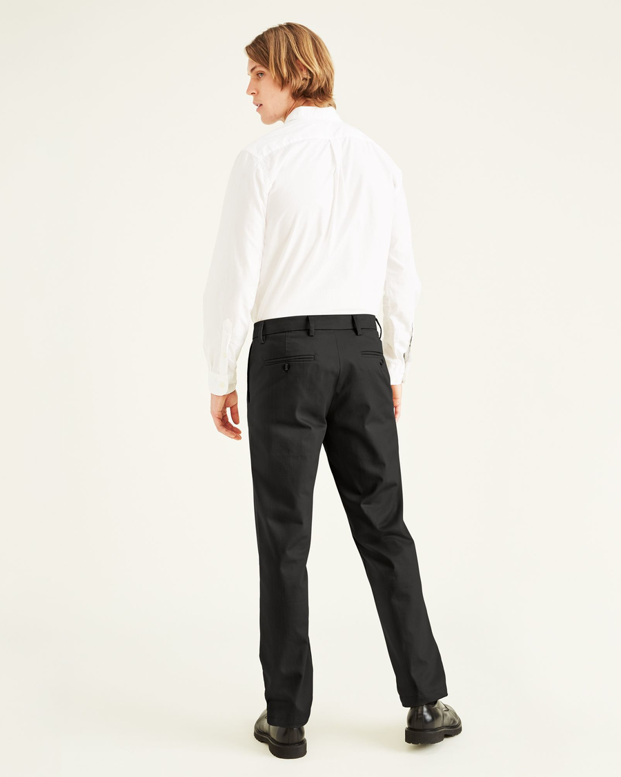 Back view of model wearing Black Signature Khakis, Slim Fit.