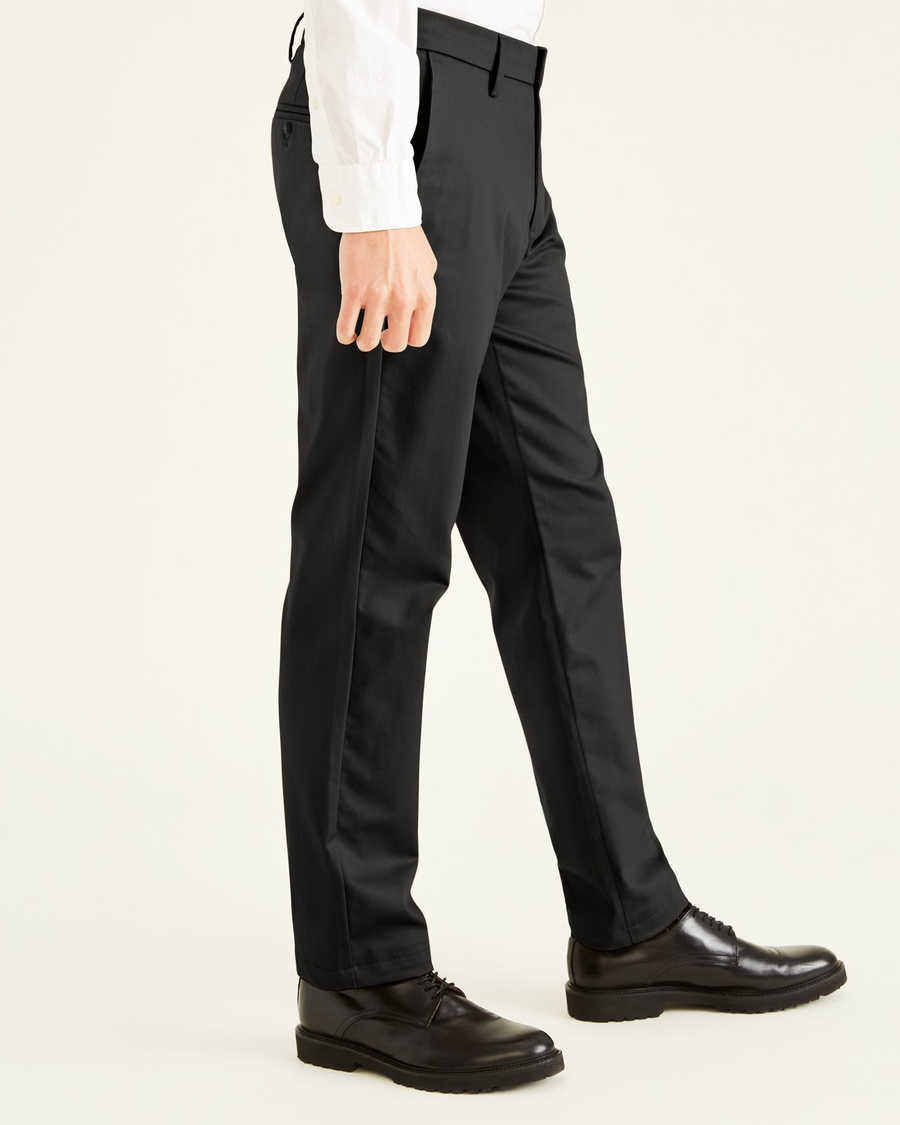 Side view of model wearing Black Signature Khakis, Slim Fit.
