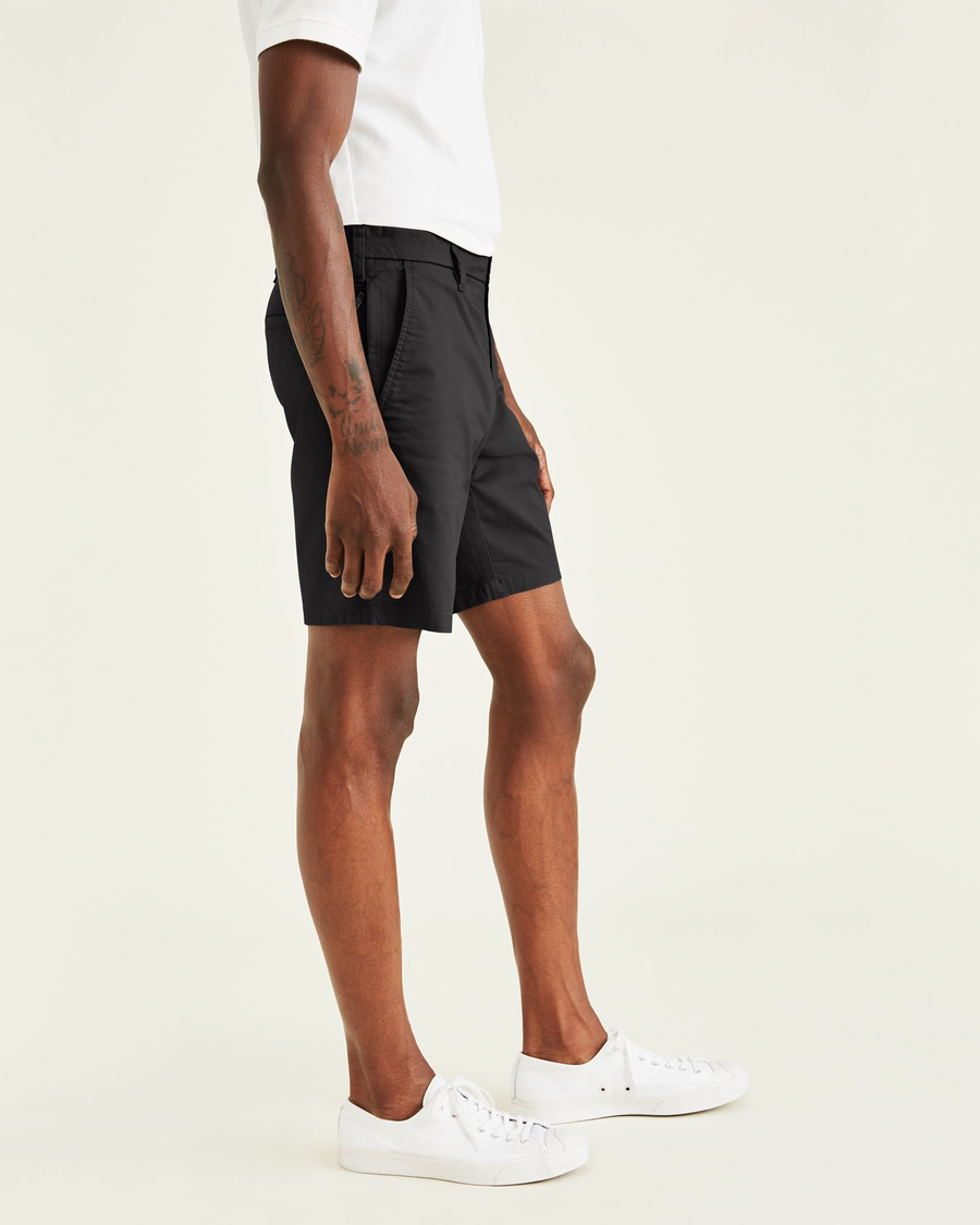 Side view of model wearing Black Ultimate 9.5" Shorts, Straight Fit.