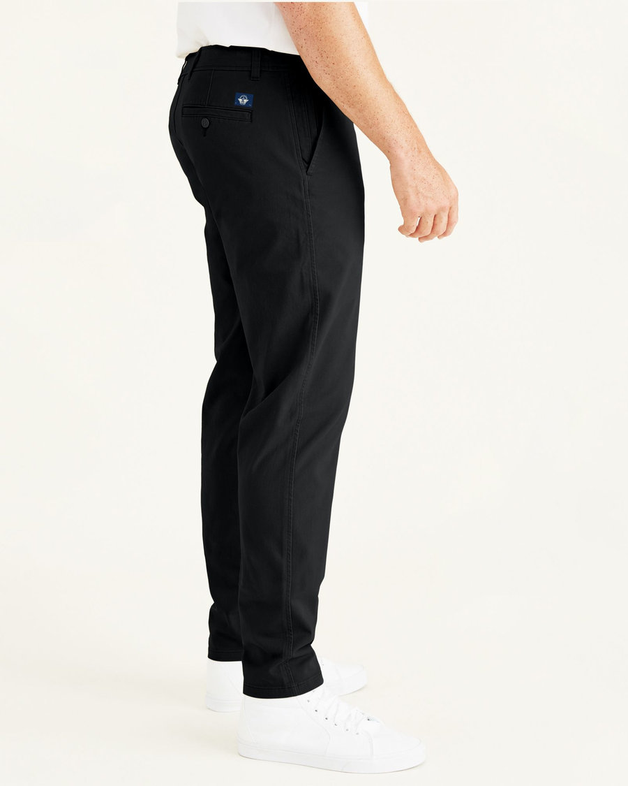 Side view of model wearing Black Ultimate Chinos, Athletic Fit (Big and Tall).