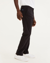 Side view of model wearing Black Ultimate Chinos, Athletic Fit.