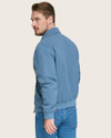 Back view of model wearing Blue Microtwill Relaxed Bomber Jacket.