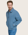 Side view of model wearing Blue Microtwill Relaxed Bomber Jacket.