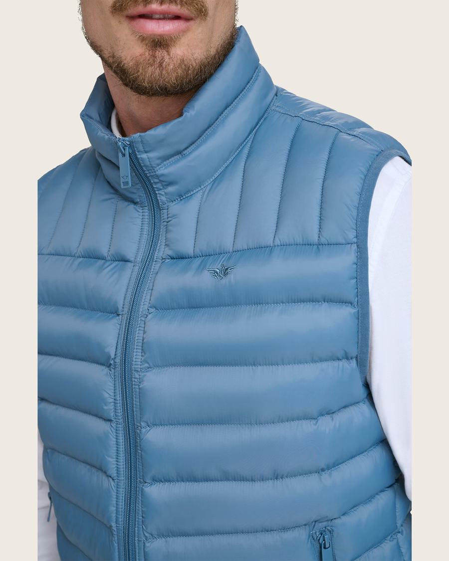 View of model wearing Blue Packable Puffer Vest.